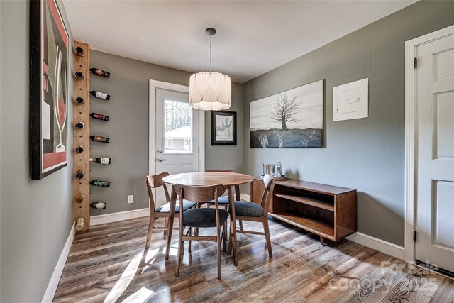 dining space featuring wood finished floors and baseboards