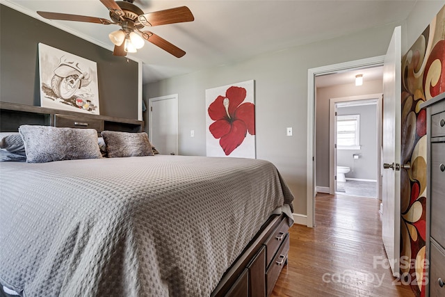 bedroom with ceiling fan, baseboards, and wood finished floors