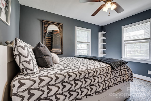 bedroom with baseboards and a ceiling fan