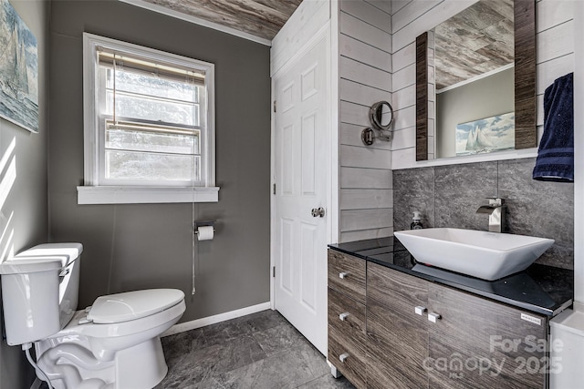 bathroom featuring vanity, baseboards, and toilet