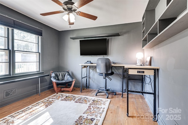 office featuring baseboards, a ceiling fan, and wood finished floors