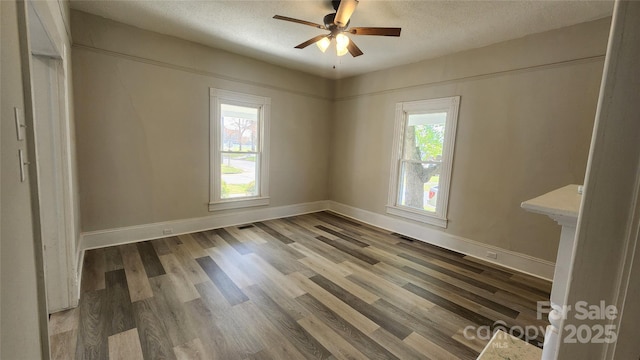unfurnished room with a textured ceiling, a ceiling fan, and wood finished floors