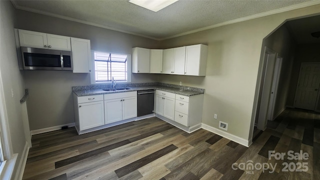 kitchen featuring dark wood finished floors, dishwashing machine, white cabinetry, stainless steel microwave, and a sink