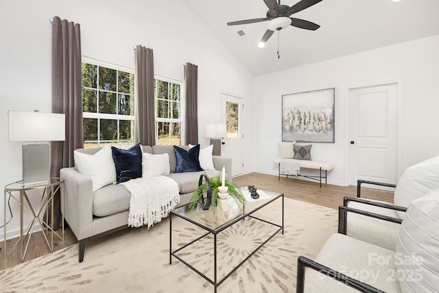 living room with a wealth of natural light, a ceiling fan, and wood finished floors