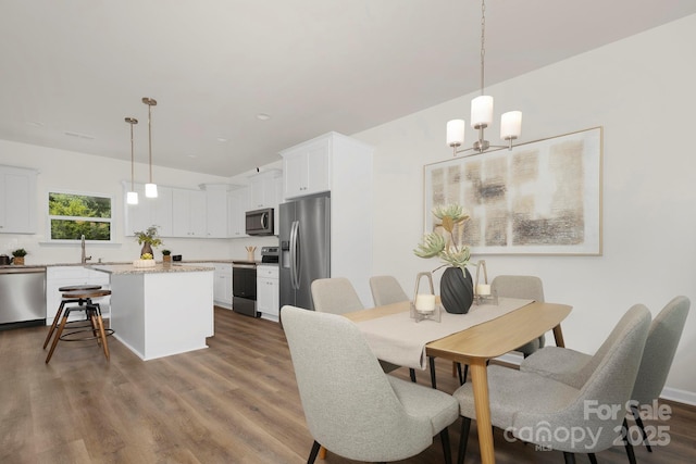 3354 W Sugar Creek Rd, Charlotte, NC 28269 - dining area featuring dark wood-style floors and an inviting chandelier
