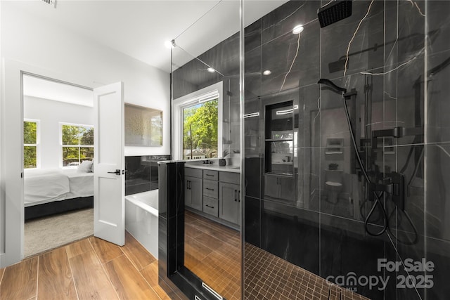 2008 St John St, Charlotte, NC 28216 - ensuite bathroom with a shower stall, vanity, a tub to relax in, and plenty of natural light