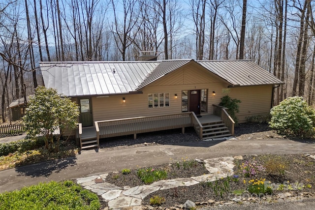 1 Sleepy Hollow Dr, Maggie Valley, NC 28751 - rustic home featuring a standing seam roof, metal roof, a wooden deck, and a chimney
