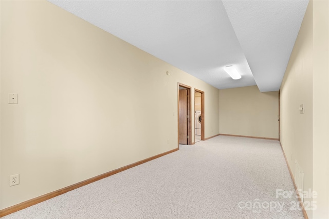 1 Sleepy Hollow Dr, Maggie Valley, NC 28751 - unfurnished room featuring washer / clothes dryer, baseboards, visible vents, a textured ceiling, and light colored carpet