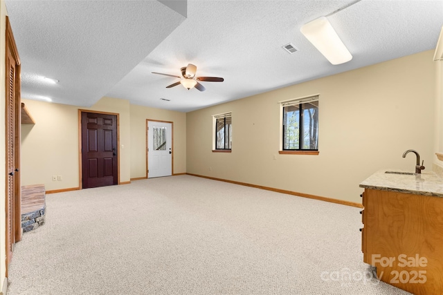 1 Sleepy Hollow Dr, Maggie Valley, NC 28751 - interior space featuring visible vents, baseboards, a sink, ceiling fan, and light colored carpet