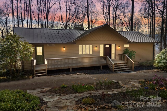1 Sleepy Hollow Dr, Maggie Valley, NC 28751 - rustic home featuring a standing seam roof, metal roof, a wooden deck, and a chimney