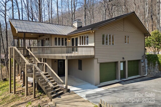1 Sleepy Hollow Dr, Maggie Valley, NC 28751 - back of property with a chimney, metal roof, aphalt driveway, and stairway