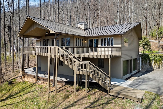 1 Sleepy Hollow Dr, Maggie Valley, NC 28751 - rear view of property with a chimney, stairway, a garage, a standing seam roof, and metal roof