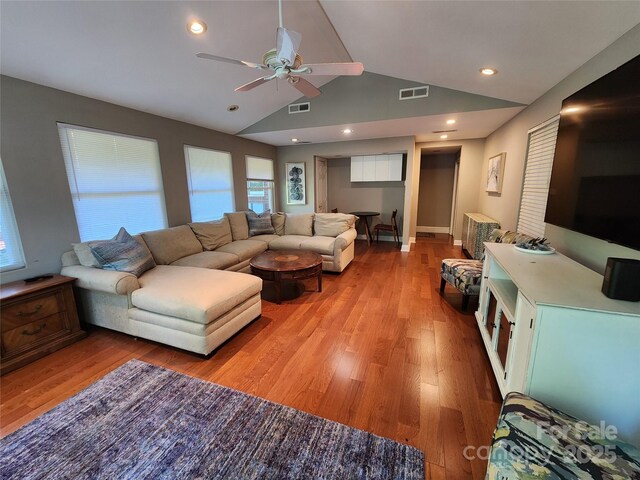 148 Palaside Dr NE, Concord, NC 28025 - living room featuring light wood finished floors, visible vents, vaulted ceiling, and ceiling fan