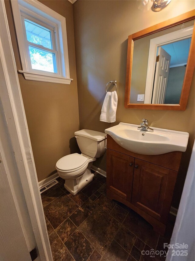 148 Palaside Dr NE, Concord, NC 28025 - bathroom featuring stone finish floor, vanity, visible vents, toilet, and baseboards