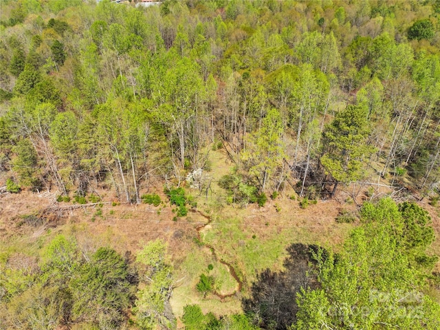 drone / aerial view featuring a view of trees