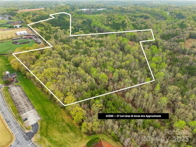birds eye view of property with a wooded view