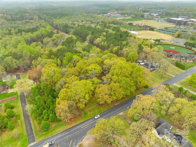 birds eye view of property with a wooded view