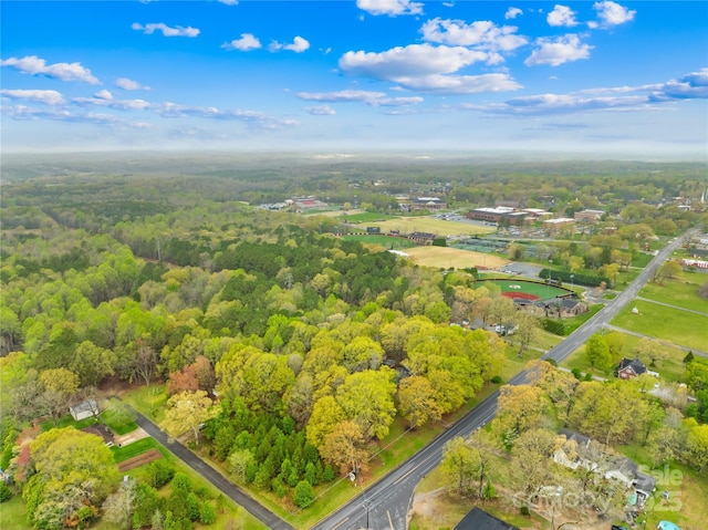 birds eye view of property with a view of trees