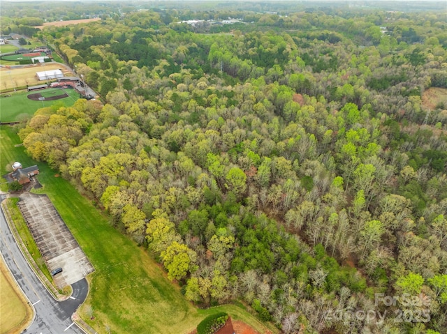 bird's eye view featuring a wooded view
