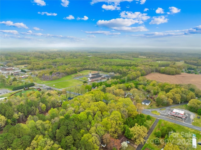 birds eye view of property featuring a wooded view