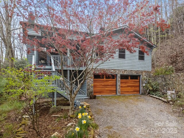63 Chestnut Forest Rd, Fairview, NC 28730 - view of front of property featuring stone siding, stairway, an attached garage, and driveway