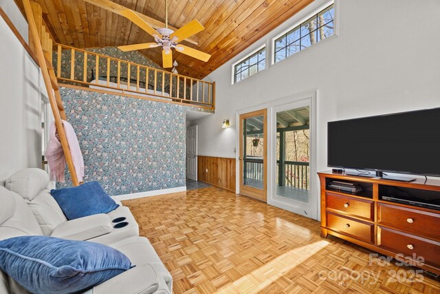 63 Chestnut Forest Rd, Fairview, NC 28730 - living area featuring a ceiling fan, high vaulted ceiling, a wainscoted wall, baseboards, and wooden ceiling