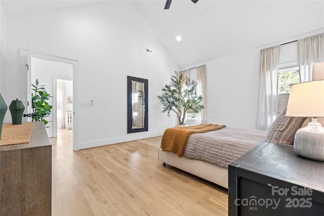 210 Walford Dr, Charlotte, NC 28208 - bedroom with high vaulted ceiling, light wood finished floors, visible vents, and baseboards