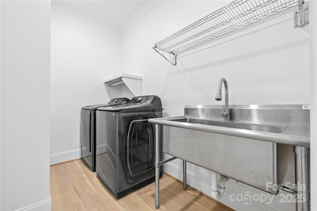 210 Walford Dr, Charlotte, NC 28208 - laundry room with light wood-type flooring, washing machine and dryer, laundry area, and baseboards