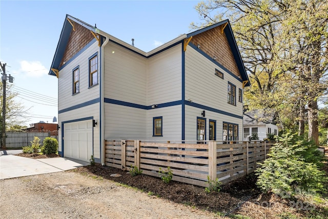 210 Walford Dr, Charlotte, NC 28208 - view of side of property with concrete driveway, a wooden deck, fence, and an attached garage