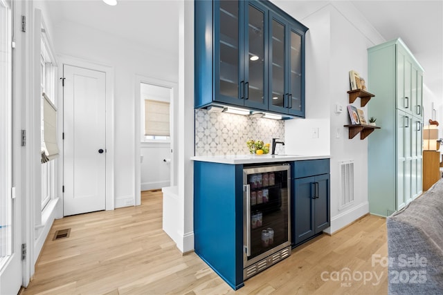 210 Walford Dr, Charlotte, NC 28208 - bar featuring wine cooler, backsplash, visible vents, and light wood-style floors