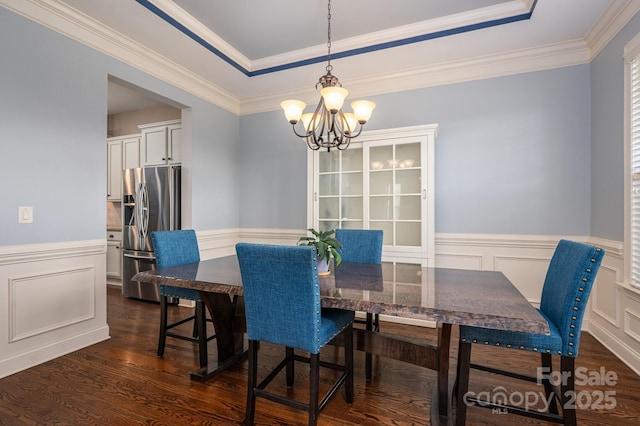 6352 Willow Farm Dr, Denver, NC 28037 - dining space with a wainscoted wall, a tray ceiling, a notable chandelier, a decorative wall, and dark wood-type flooring