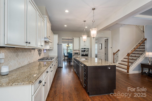 6352 Willow Farm Dr, Denver, NC 28037 - kitchen featuring under cabinet range hood, backsplash, appliances with stainless steel finishes, and recessed lighting