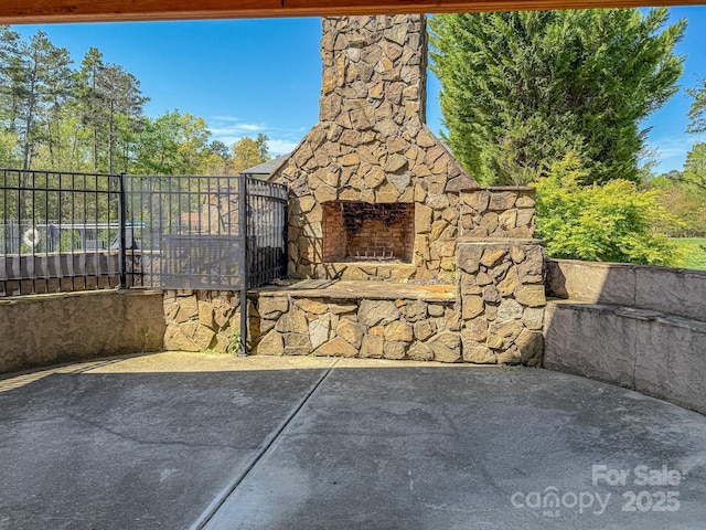 6352 Willow Farm Dr, Denver, NC 28037 - view of patio with an outdoor stone fireplace and fence