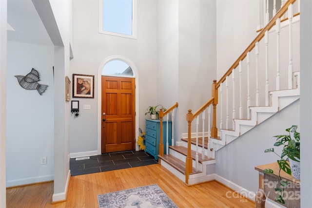 1050 Merrywood Dr, Newton, NC 28658 - foyer with stairs, a towering ceiling, baseboards, and wood finished floors