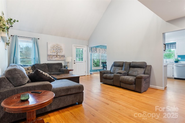 1050 Merrywood Dr, Newton, NC 28658 - living area featuring light wood-style flooring, high vaulted ceiling, and baseboards