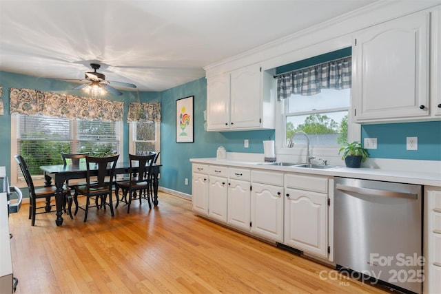1050 Merrywood Dr, Newton, NC 28658 - kitchen with light wood-style flooring, white cabinets, ceiling fan, stainless steel dishwasher, and a sink