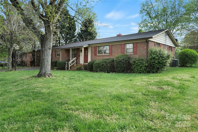 single story home with brick siding, a front lawn, cooling unit, and a chimney