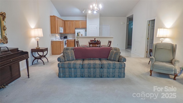 living area with light carpet, high vaulted ceiling, and a notable chandelier