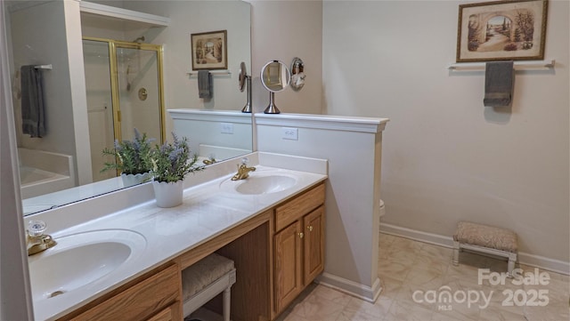 full bathroom featuring a shower stall, double vanity, a sink, and toilet