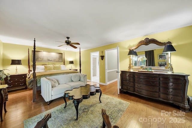 bedroom with crown molding, ceiling fan, and wood finished floors