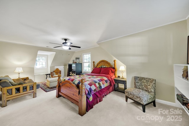 carpeted bedroom with crown molding, a ceiling fan, baseboards, and lofted ceiling