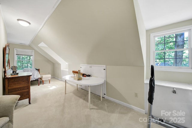 interior space featuring baseboards, light carpet, and vaulted ceiling