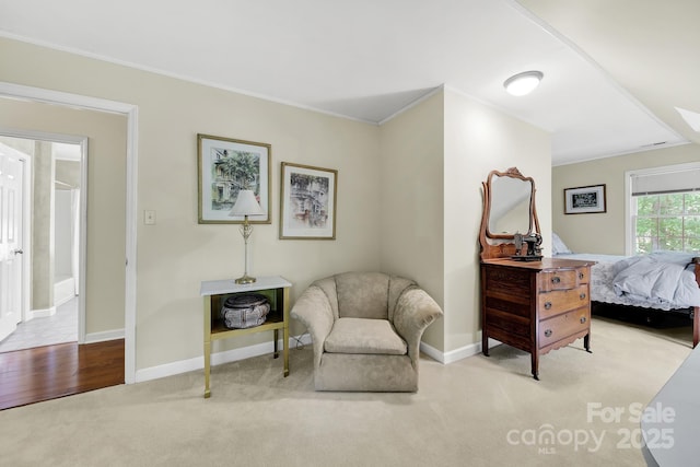 sitting room with baseboards, carpet flooring, and ornamental molding