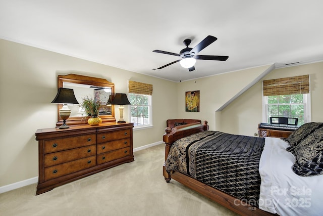 carpeted bedroom with baseboards, ornamental molding, ceiling fan, and visible vents