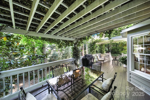 wooden deck featuring area for grilling and outdoor dining area