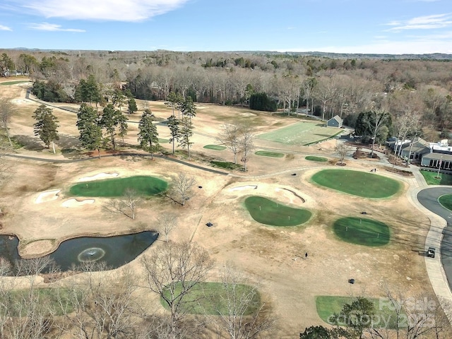 drone / aerial view featuring golf course view and a wooded view