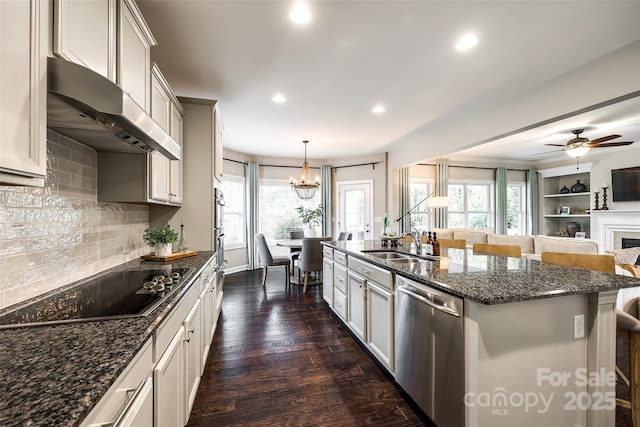 405 Five Leaf Ln, Waxhaw, NC 28173 - kitchen with stainless steel dishwasher, exhaust hood, a kitchen bar, a sink, and black electric stovetop