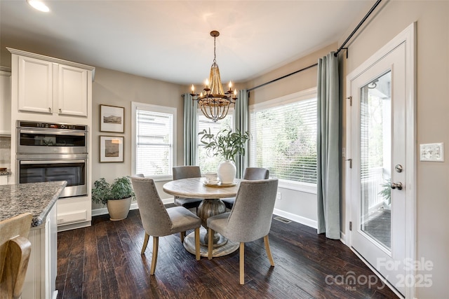 405 Five Leaf Ln, Waxhaw, NC 28173 - dining area with dark wood-style flooring, baseboards, and a notable chandelier