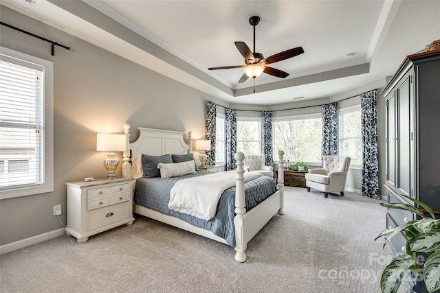 405 Five Leaf Ln, Waxhaw, NC 28173 - bedroom featuring light carpet, multiple windows, a tray ceiling, and ornamental molding
