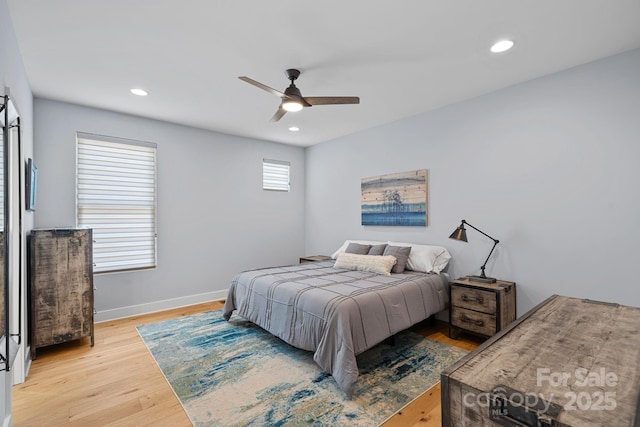 bedroom with wood finished floors, ceiling fan, baseboards, and recessed lighting